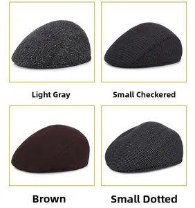 Detail view of four men's newsboy caps in light grey, grid, brown, and dot patterns