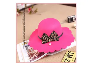 Detail of pink wool felt hat with leopard bow and elegant wavy scalloped edge design