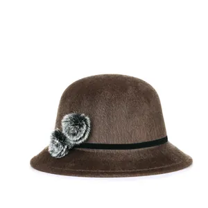 Women's warm dark brown cloche hat with stylish faux fur pom-poms and elegant rhinestones