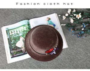 Detailed embroidery of red roses on a vintage coffee brown faux mink wool hat