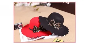 Detail of scalloped brim wool felt hats with leopard bow and pearl accents for women