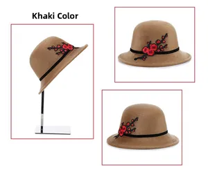 Detail view of khaki faux mink fur hat with elegant red plum embroidery and black ribbon