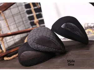 Close-up of vintage newsboy caps in herringbone and plaid patterns with leather details