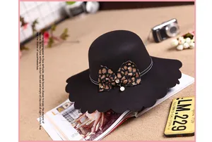 Detail of wool felt hat with scalloped brim, leopard bow, pearl and crystal accents