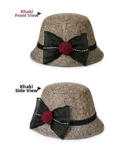 Detail view of khaki wool bucket hat with black ribbon bow and red fabric flower