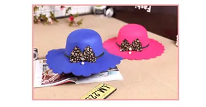 Close-up of wavy brim hats with leopard bows, pearls and rhinestones decoration