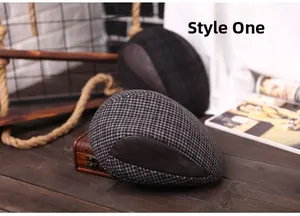 Detail of gray houndstooth newsboy cap with brown leather trim and retro sewing finish
