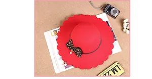 Top view of red wool felt fedora featuring scalloped brim and leopard bow detail