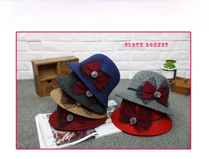 Detail of wool fedora hats featuring mesh bow ties and pearls in assorted colors
