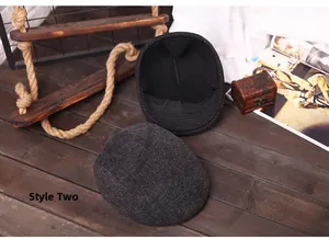 Detail view of winter flat caps in grey herringbone wool with ear protection flaps