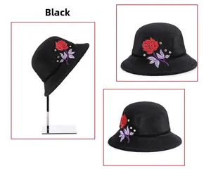 Detail of elegant black faux fur bucket hat with red rose embroidery and rhinestones