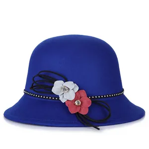 Women's dark blue wool felt hat featuring floral accents and silver studs on a white background