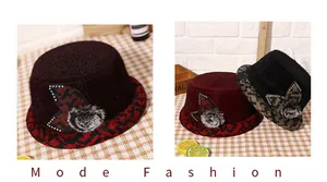 Detail of winter faux mink fur bucket hat with rhinestone leaf and pompom ornament