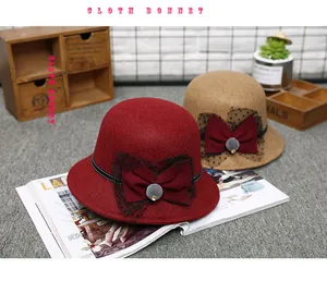 Close-up of elegant wool fedora hats with polka dot mesh bows and plush pom pom detail