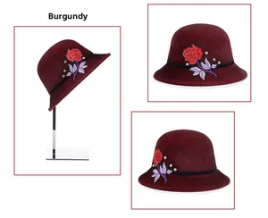 Detail of wine red winter hat featuring rose embroidery and sparkling rhinestones decoration