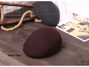 Detail view of winter flat cap for elderly men in dark brown wool fabric on wood floor