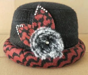 Detail of winter bucket hat with faux fur top, patterned brim and crystal flower accent