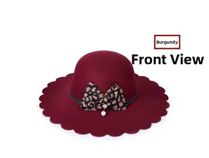 Detail of wine red wool fedora hat with scalloped edge and leopard bow decoration