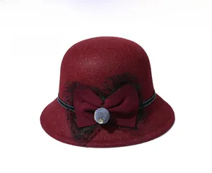 Detailed view of wine red wool fedora hat featuring a bow and polka dot lace trim