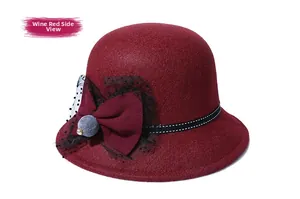 Detail view of wine red cloche hat featuring a large bow with mesh and polka dot ribbon