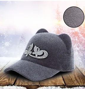 Detail of plush grey equestrian cap with cat ears and butterfly rhinestone embellishment
