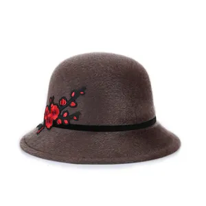 Elegant brown faux mink cloche hat with floral embroidery and black band for winter