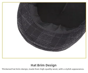 Close-up of the thick brim on a grey plaid woolen flat cap with textured fabric detail