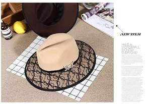 Detail of wool fedora hat with black lace brim and gold rhinestone butterfly buckle
