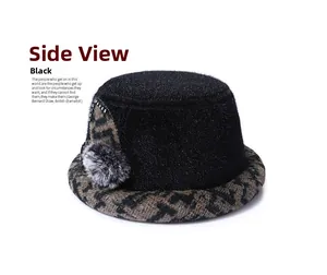 Side view of black faux fur winter bucket hat with brown houndstooth trim and pompom detail