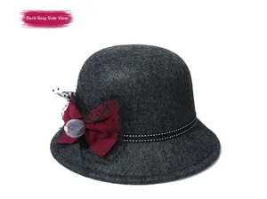 Detail of dark grey wool felt hat featuring a burgundy bow and decorative mesh veil