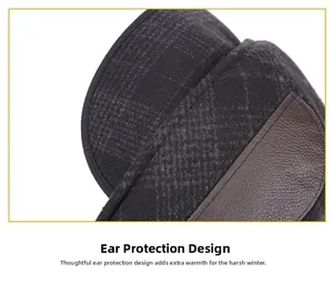 Detail view of winter hat showing plaid fabric and brown leather ear flap stitching