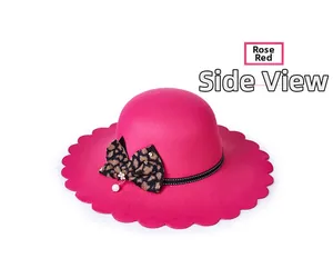Side view of rose red wool fedora with wavy brim and leopard print bow detail