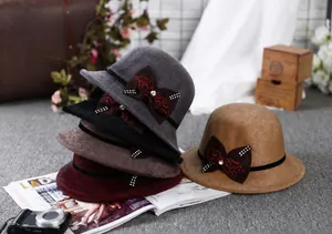 Detail view of winter wool fedoras in multiple colors with rhinestone bow decoration