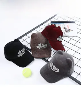 Detail view of multi-color feline ear baseball caps with rhinestone butterfly decor