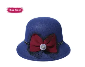 Detail of vintage navy wool cloche hat featuring burgundy bow and black polka dot mesh