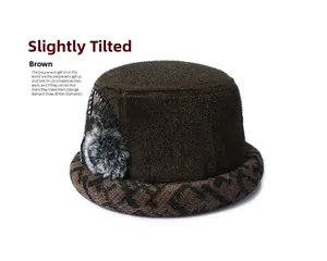 Detail of a brown plush winter hat for elderly women with plaid brim and pompom accent
