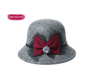 Detailed front view of light grey wool bucket hat with red bow and polka dot mesh