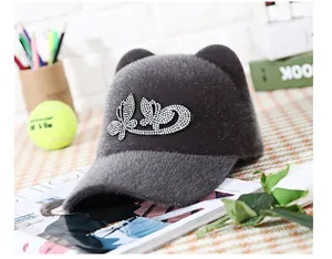 Detail of plush grey equestrian cap with cute cat ears and sparkling rhinestone bow motif