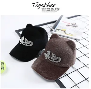 Close-up of cat-ear equestrian hats with sparkling rhinestone butterfly accents
