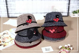 Detail of wool cloche hats with floral embroidery and rhinestones in various colors