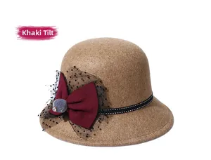 Detail of khaki wool felt claret bow hat with black polka dot mesh and fur ball