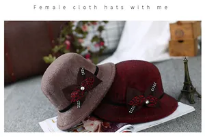 Close-up of elegant wool felt bucket hat with rhinestone bow and ethnic pattern detail