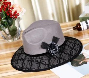 Detail of grey wool felt hat with black lace overlay and decorative rhinestone bow