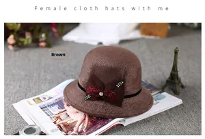 Detail of brown wool felt hat featuring rhinestone bow and elegant winter style