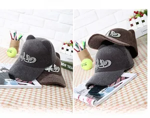 Detail of cat-ear equestrian hats with rhinestone butterfly decoration in dark grey and coffee