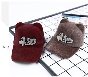 Detailed plush texture of cat ear caps with sparkling rhinestone butterfly patterns