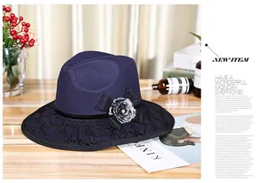 Close-up of dark blue felt fedora hat with wool texture and floral bow detail