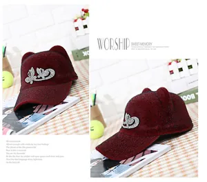 Macro detail of wine red faux mink fur equestrian cap with rhinestone butterfly and ears