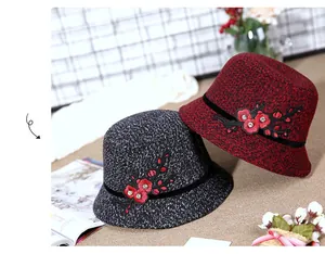 Detail of wool cloche hats with floral embroidery and sparkling rhinestones