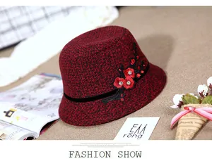 Detail of burgundy wool bucket hat with floral embroidery and sparkling crystal accents
